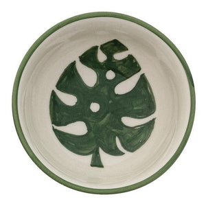 CREATIVE COOP's HAND-PAINTED STONEWARE BOWLS WITH BOTANICAL DESIGN, some holding green peppers or grains, are arranged on a light beige surface—each bowl highlights its unique handcrafted artistry.