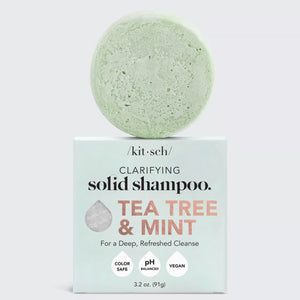 A light green KITSCH solid shampoo bar sits atop its packaging marked "TEA TREE & MINT CLARIFYING SHAMPOO BAR, For a Deep, Refreshed Cleanse." Infused with tea tree oil, as a 4ocean Certified Cleanup Partner, KITSCH helps reduce single-use plastic.