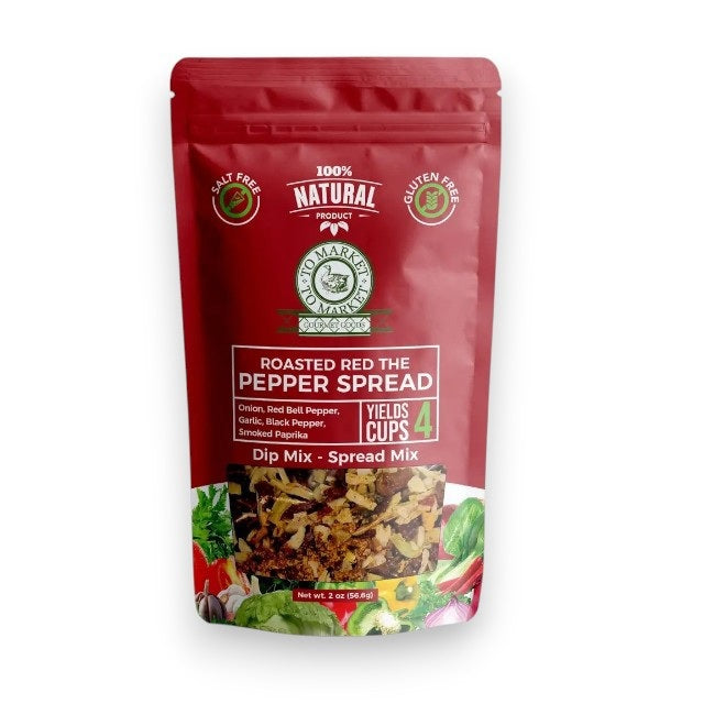 A red packet of TO MARKET - ROASTED RED PEPPER SPREAD DIP MIX from TO MARKET- DIPS &amp; SPREADS stands upright beside a white bowl filled with creamy dip and crackers. The packaging highlights that the mix is all-natural, makes 4 cups, and is both gluten-free and salt free. Infused with smoked paprika, this bold, smoky spread is perfect for adding robust flavor to any gathering.