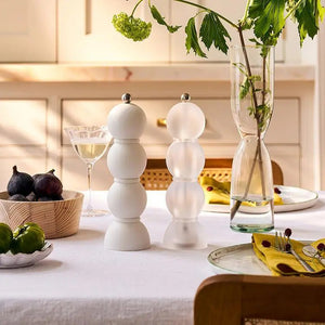 The ADDISON ROSS LONDON Scandi Bobbin Salt or Pepper Mill (23 cm) features a modern white design with three stacked spheres, a metallic top knob, and a durable ceramic grinder, shown upright against a plain white background.