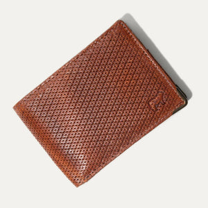 Two WILL LEATHER GOODS THE INDUSTRIALIST BILLFOLD wallets in ginger pindot full-grain leather are shown: one open with card slots and ID window, the other closed with an embossed dog logo on the bottom right corner.