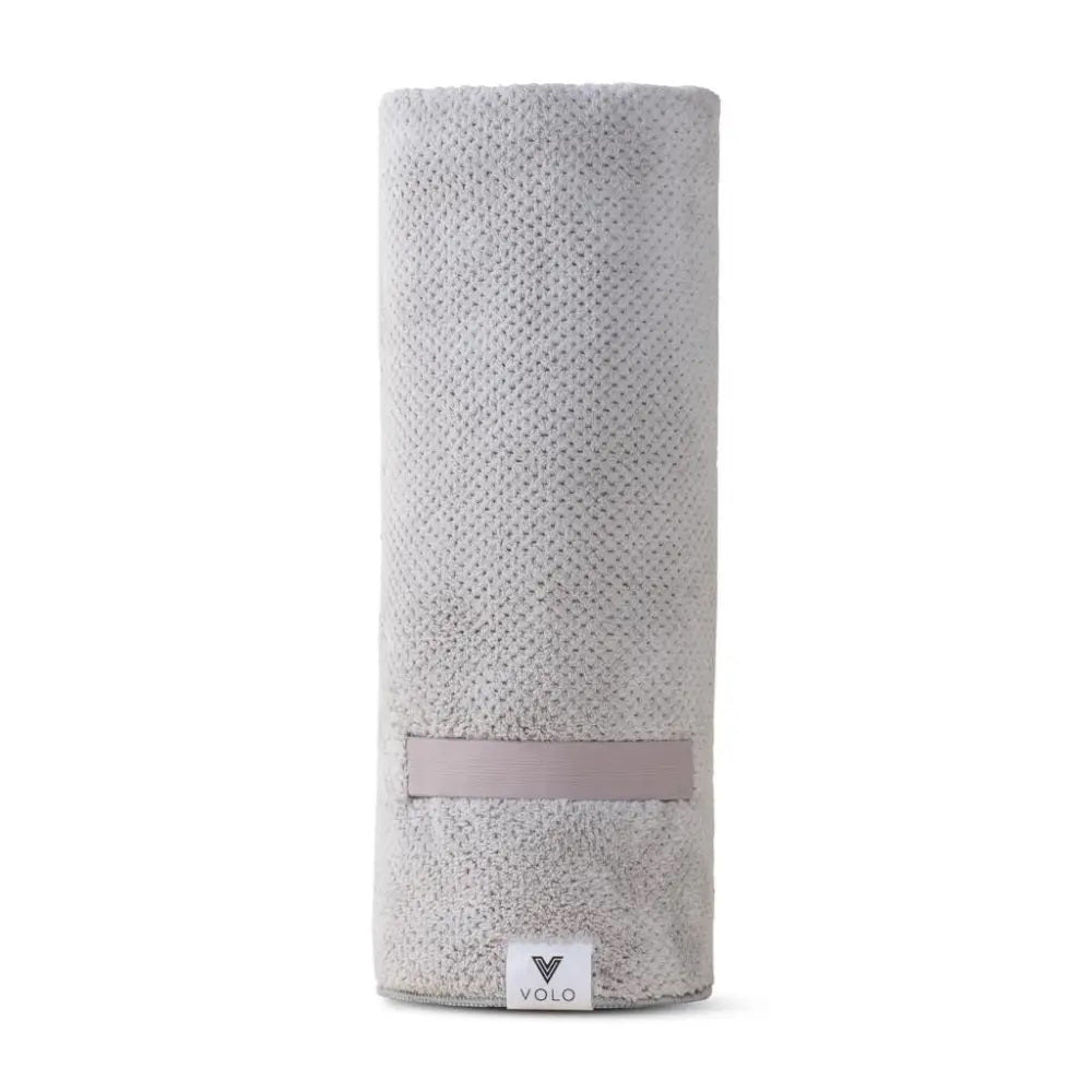 A packaged VOLO BEAUTY HAIR HERO TOWEL with soft Nanoweave fabric is in a clear bag, showing two Best of Beauty awards on the top right, set against a beige background.