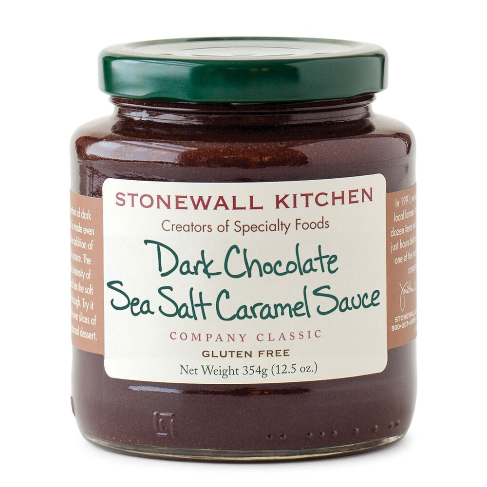 A jar of STONEWALL KITCHEN- DARK CHOCOLATE SEA SALT CARAMEL SAUCE from Stonewall Kitchen, featuring a green lid and a white label that includes details such as “gluten free” and “net weight 354g (12.5 oz).”.