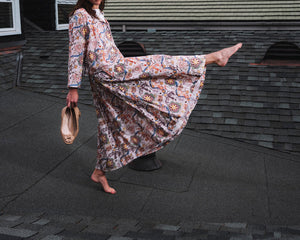 The Lulu Skirt by THE LITTLE PROJECT features a vibrant Liberty of London Cirque print with animals and floral designs in orange, purple, green, and yellow on an off-white base. Its elastic waist offers comfort and style.