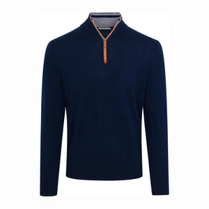 A man wearing the COLLARS AND CO - CASHMERE TOUCH AUSTRALIAN MERINO WOOL 1/4 ZIP SWEATER IN NAVY WITH BROWN SUEDE TRIM and a collared shirt stands outside a white building with large windows, looking to the side with his arms folded.