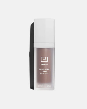 A 30 ml (1.0 fl oz) bottle of U BEAUTY - THE SUPER TINTED HYDRATOR SHADE 10, a dewy skin tint and moisturizer, stands upright with a white cap and frosted body against a light grey background.
