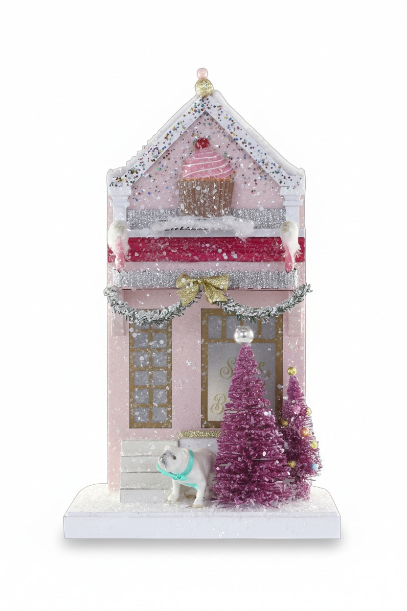 11-inch pink SUGAR AND SPICE BAKE HOUSE ornament featuring a cupcake on the roof, a small dog out front, and two pink bottle brush trees.