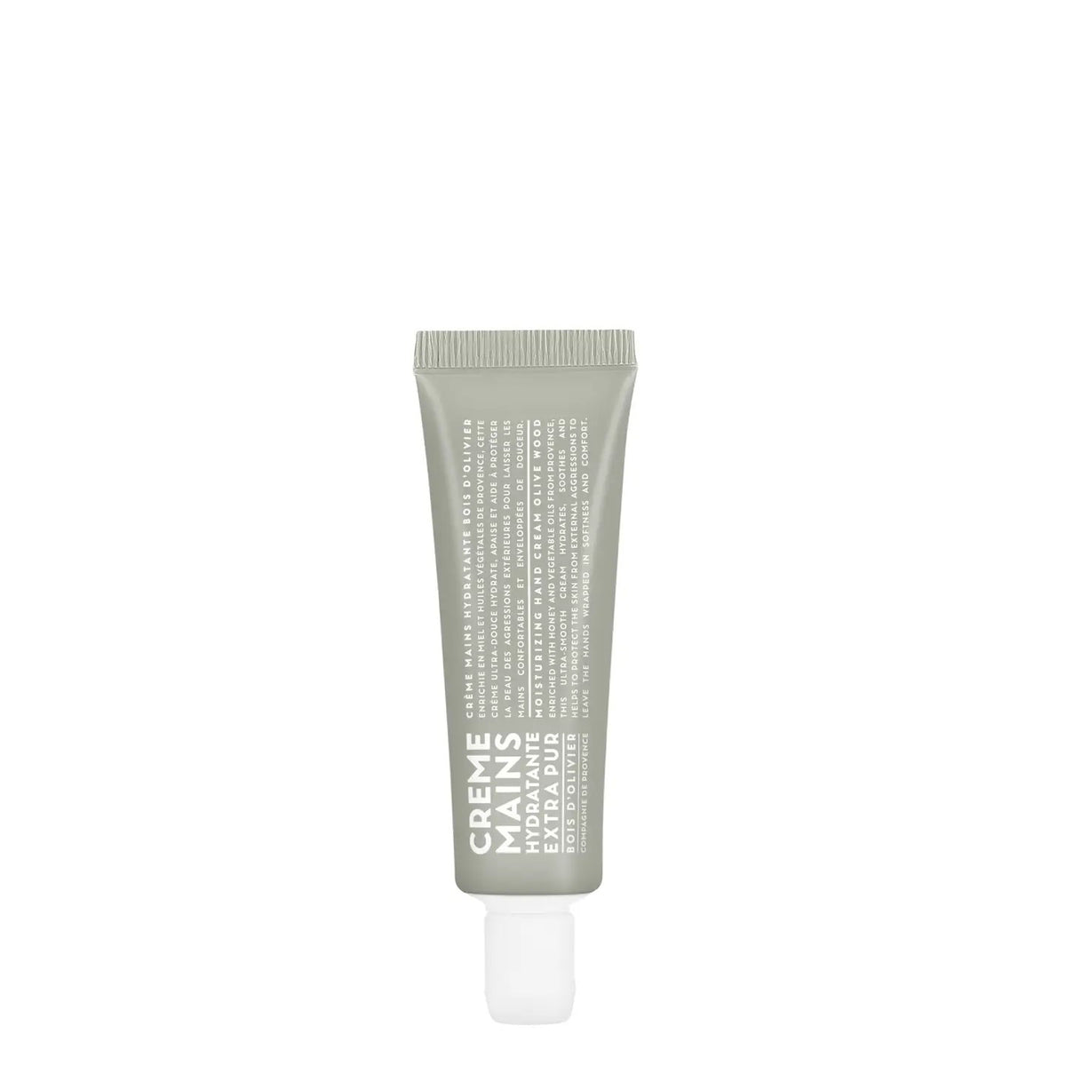 A compact gray tube of CIE LUXE BRANDS' COMPAGNIE DE PROVENCE TRAVEL HAND CREAM OLIVE WOOD 1OZ stands upright on a plain white background, featuring white "CREME MAINS HYDRATANTE EXTRA PURE" text on the front.