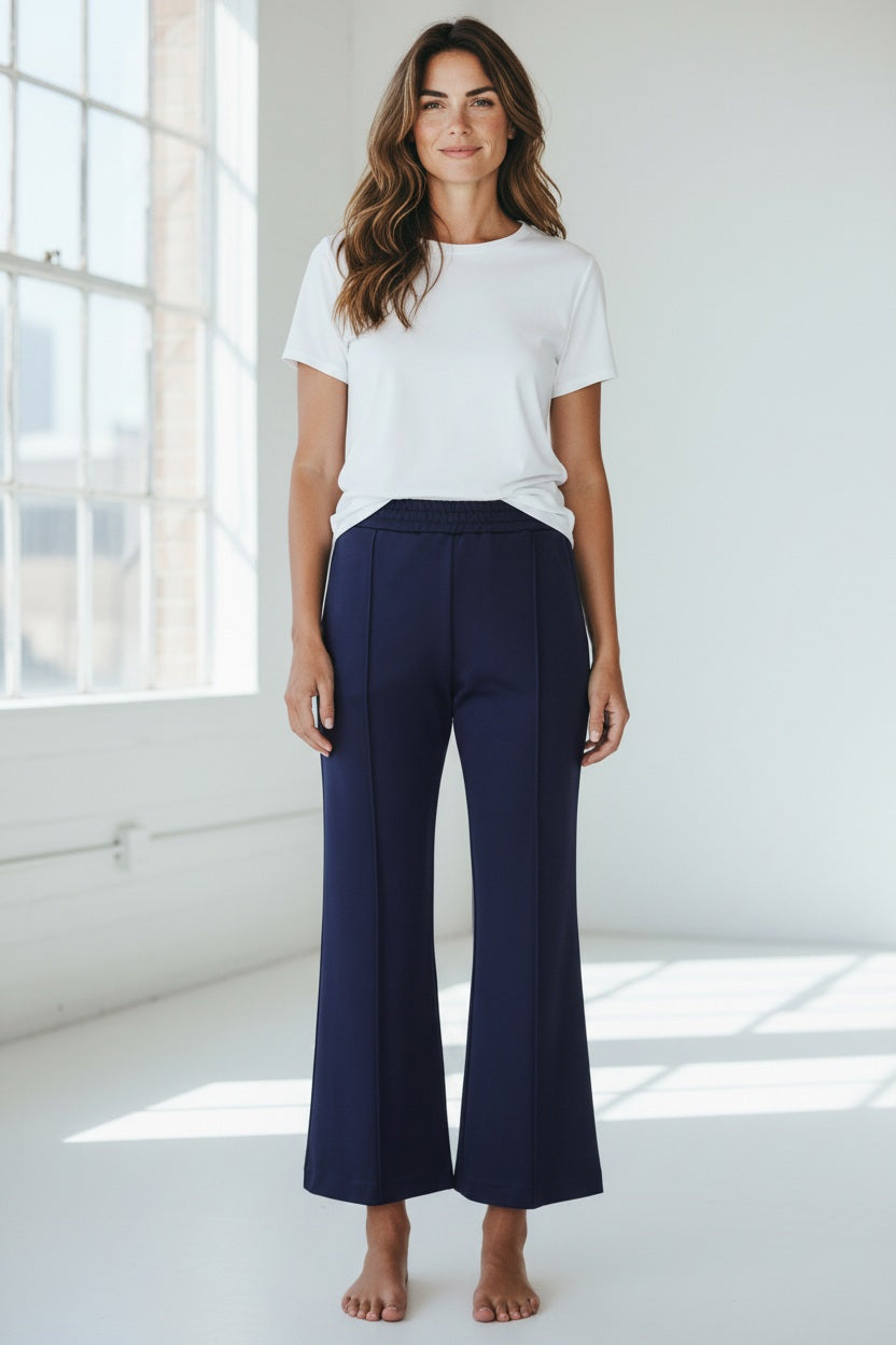 A person wears MEIMEIJ Pull-On Straight Leg Cropped Pants—black, high-waisted with an elastic waistband and subtle front seam—standing against a plain white background.