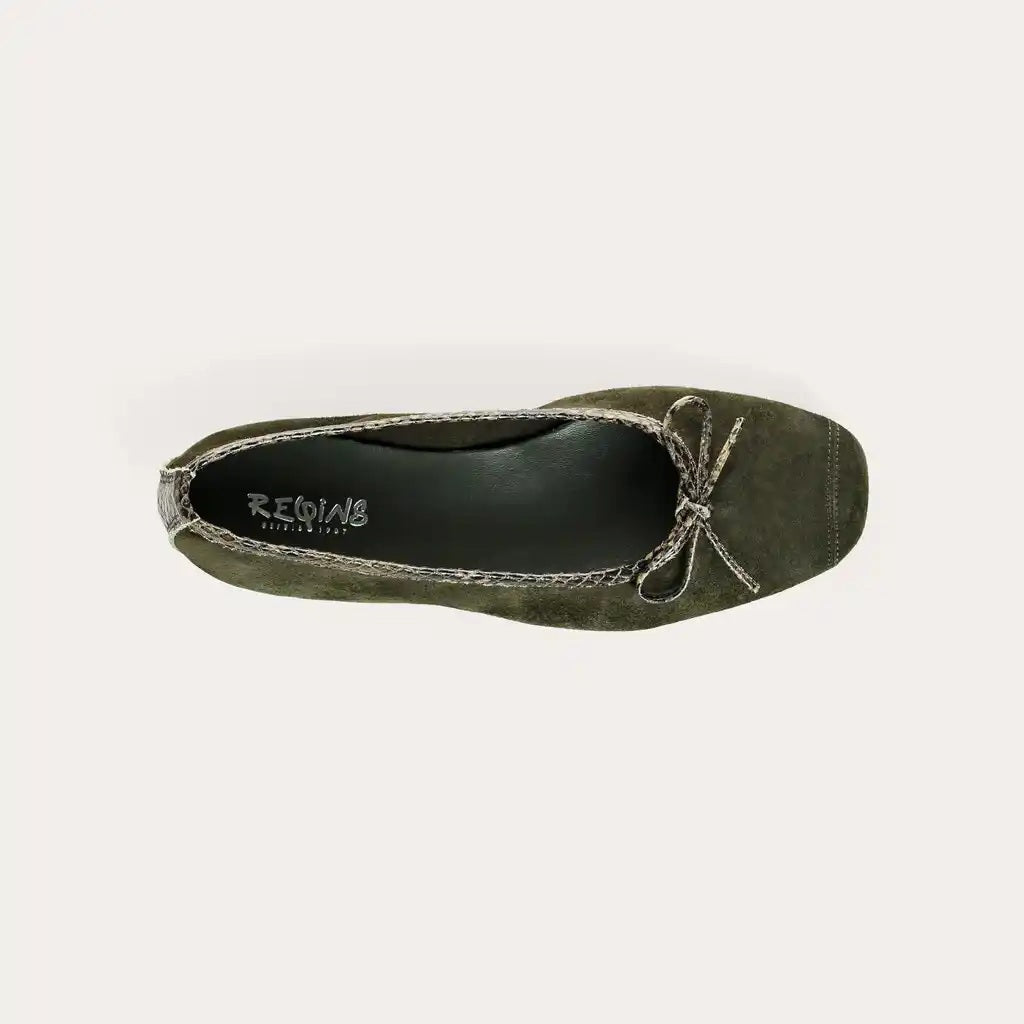 The REQINS “Harmony Suede Ballerina Flats with Python Trim in Khaki Foncé” are displayed in profile on a white background, featuring green suede material, a small bow on the toe, braided trim around the opening, and a subtle python-print accent.