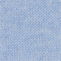 A woman with long, wavy blonde hair wears the KINROSS CASHMERE Openwork Crew Neck Cotton Sweater in Skyway by KINROSS, paired with light blue jeans. She stands against a plain white background and smiles softly.