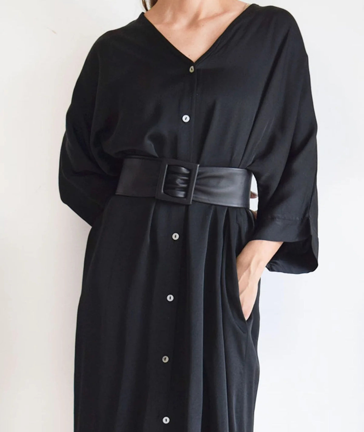 The APROPOS BELT by ADA is a handcrafted brown leather belt with a wide band and smooth texture. Made from genuine Argentinian leather, it features a rectangular buckle, showcased on a plain white background.