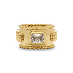 The CAPUCINE DE WULF - BERRY HAMMERED BAND RING features a wide hammered gold band with a textured finish, central rectangular CZ diamond, rope borders, floral side details, and an anti-tarnish coating for lasting shine.