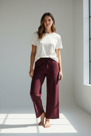 The FRANK & EILEEN Catherine Long Sweatpant in Currant is a pair of 100% cotton, wide-leg sweatpants with a drawstring waistband, shown laid flat on a white background.