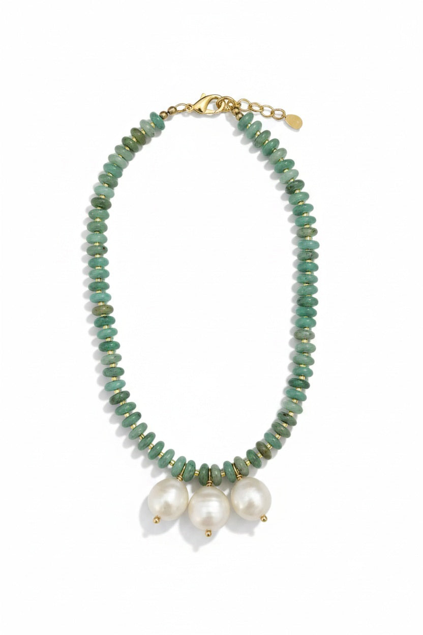 The SANDRINE FRANCE STUDIO - MADELEINE NECKLACE by SANDRINE FRANCE STUDIO is a handcrafted beaded green necklace featuring vibrant amazonite stones, accented with three large baroque pearls at the center and finished with a gold clasp closure—an elegant piece of handmade jewelry.