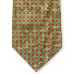 The PETER-BLAIR Bespoke Small Squares Silk Tie in Green by BIRD DOG BAY features a geometric red square pattern and is handmade in New York, shown rolled up on a white surface.