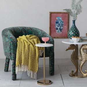 The CREATIVE COOP MARBLE TOP GOLD MARTINI TABLE features a white marble top, a slim gold pedestal stem, and a circular gold base, shown against a white background.