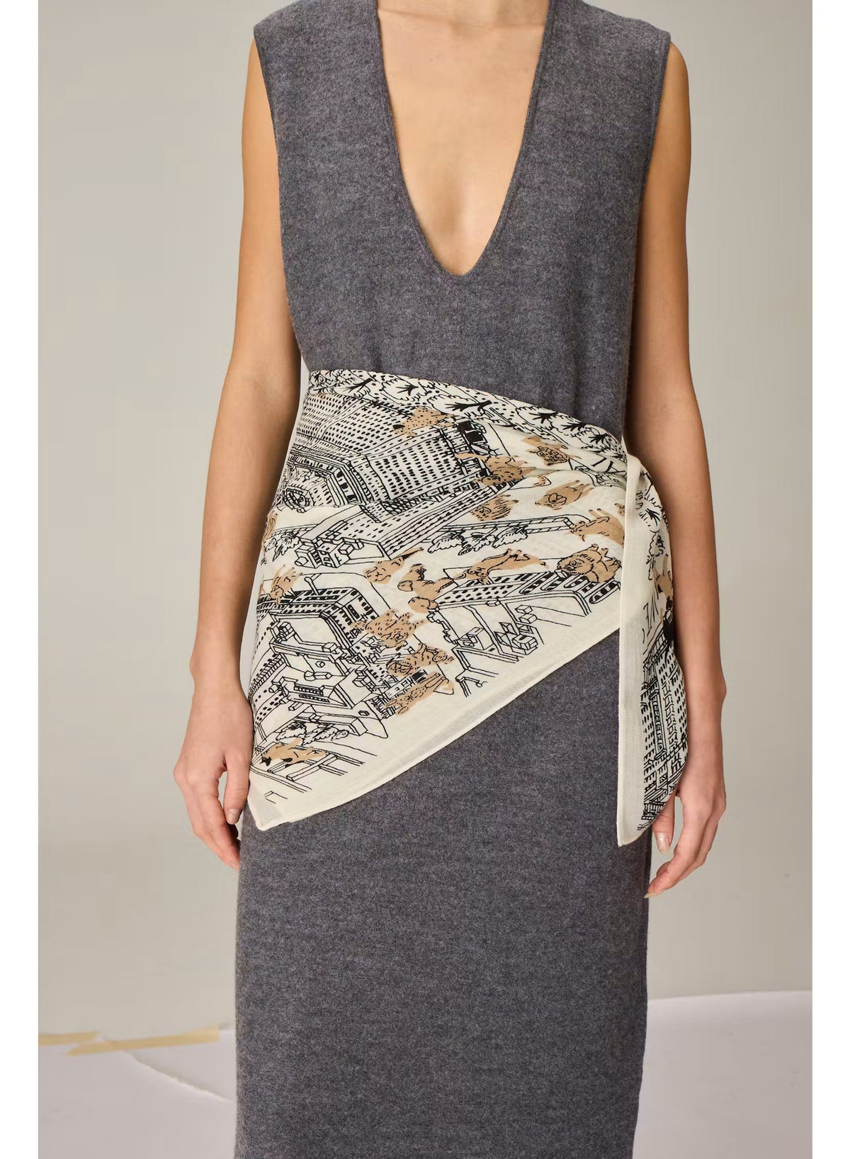 An intricately illustrated map of Central Park, New York, featuring surrounding buildings, trees, and warmly dressed people wrapped in cozy scarves—many reminiscent of the INOUI EDITIONS - CENTRAL PARK WOOL SCARF IN BEIGE by INOUI—comes alive with handwritten labels and a sepia-toned palette. Inspired by the inviting warmth and comfort of this 100% wool scarf made in India, the artwork beautifully evokes the iconic cityscape’s welcoming atmosphere.