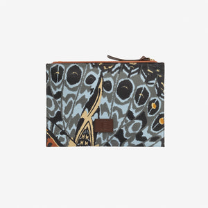 The INOUI EDITIONS - PAPILLON (BUTTERFLIES) POUCH by INOUI is a rectangular pouch with a zippered top, featuring a vibrant abstract butterfly wing print and Italian leather trim, finished with a small brown leather patch on the front.