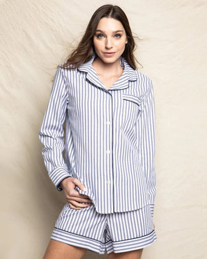 A neatly folded set of elegant pajamas from the FEARRINGTON LIFESTYLE COLLECTION featuring a classic French ticking design. The navy and white striped twill short set has a button-up front, a chest pocket adorned with a black sheep emblem, and a collar. The label "Petite Plume" is visible, and an attached tag displays the same brand name and logo.