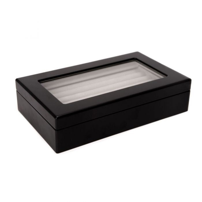 The BEYBERK INTERNATIONAL CUFFLINK BOX IN MATTE BLACK WOOD WITH GLASS TOP has a transparent lid revealing a light, cushioned interior with multiple watch slots.