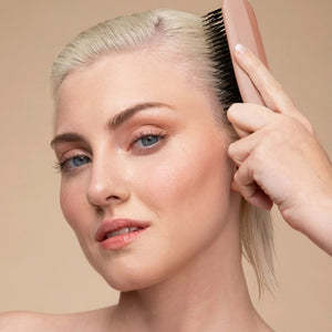 A KITSCH - Scalp Renewal Brush in Terracotta is displayed beside its box packaging, which features the product name and emphasizes its gentle, soothing scalp massage benefits as well as its eco-friendly materials. This nylon bristle brush by KITSCH is ideal for refreshing your scalp and effortlessly promoting healthy hair.