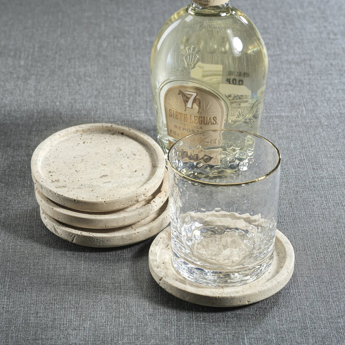 The ZODAX MARBLE TRAVERTINE COASTER SET features four round marble coasters—three stacked and one flat—displayed on a white background.