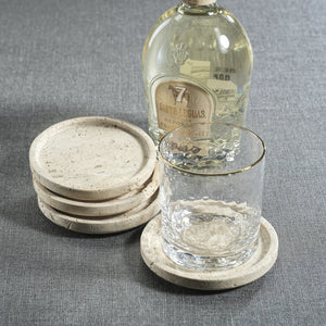 The ZODAX MARBLE TRAVERTINE COASTER SET features four round marble coasters—three stacked and one flat—displayed on a white background.