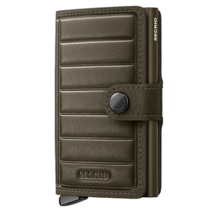 A SECRID - PREMIUM MINIWALLET+ EMBOSS LINES IN CEDAR, featuring embossed lines in a textured cedar hue and equipped with a snap button closure reminiscent of the iconic Secrid wallet design, is displayed standing upright against a white background.