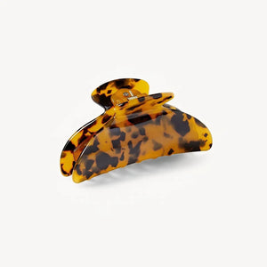The MACHETE - MIDI HEIRLOOM CLAW IN TORTOISE is a midi hair clip crafted from Italian acetate with a tortoiseshell pattern and interlocking teeth, displayed against a plain white background.
