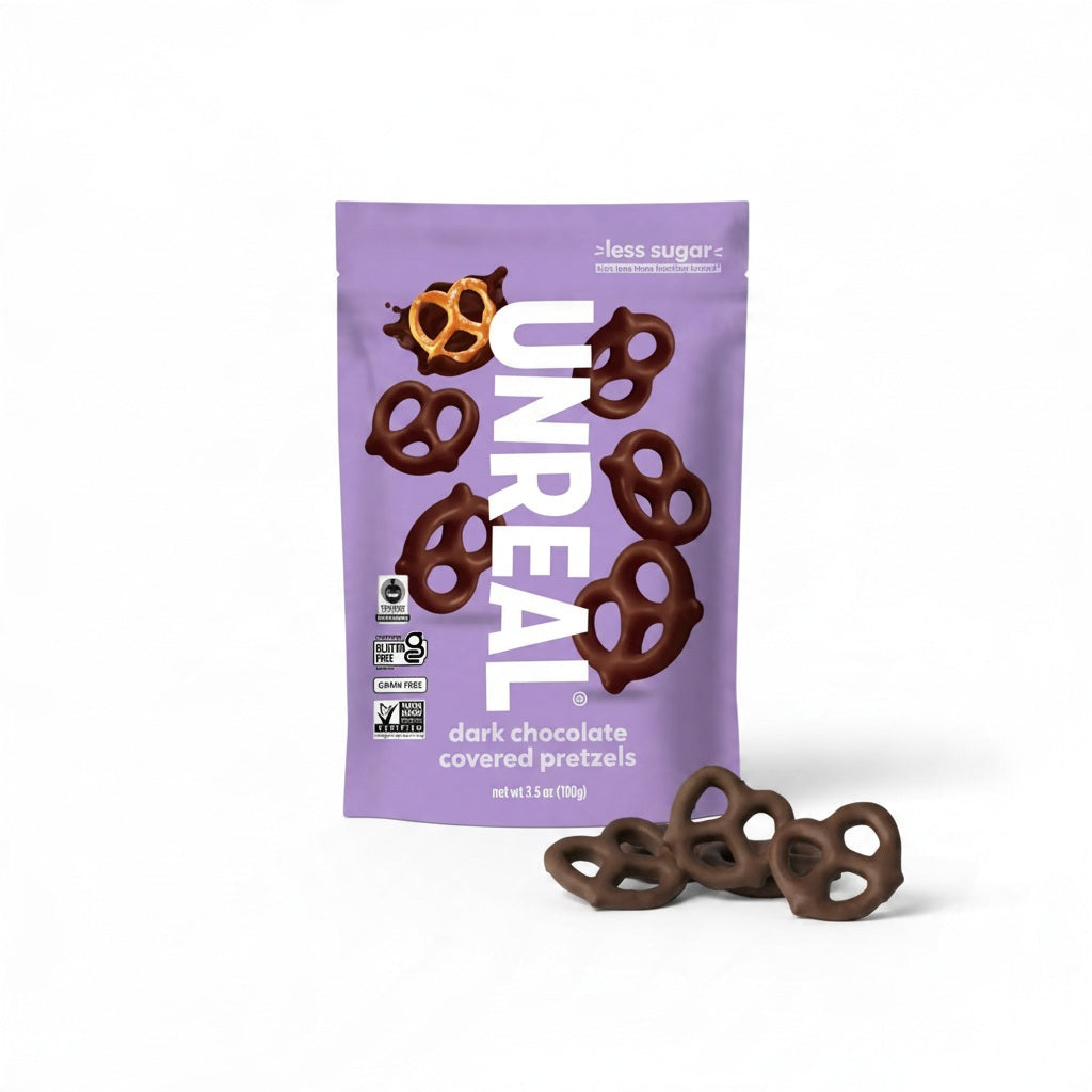 Purple bag of UNREAL - DARK CHOCOLATE COVERED PRETZELS with a few loose pretzels in front.