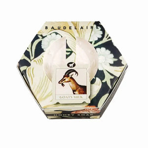 A partially open hexagonal box of BAUDELAIRE GOATS MILK HONEY SOAP 3.5OZ reveals the soap inside. The floral packaging with a goat’s head image makes it ideal for sensitive skin.