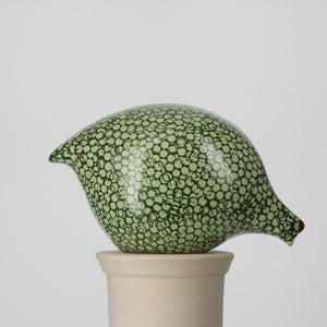 A ceramic sculpture called the "Large Pecking Ceramic Guinea in Red Spotted White" by Les Ceramiques de Lussan, featuring a design reminiscent of French guinea hens with a speckled white and orange pattern. It showcases a small head with a short beak, mounted on a light-colored cylindrical base against a plain background.