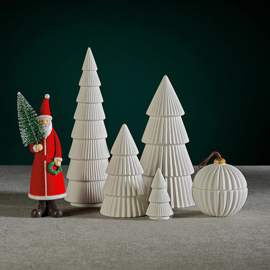 The ZODAX CERAMIC HOLIDAY TREE WHITE is a 12.70 cm x 26.04 cm white ceramic sculpture with four fluted tiers and a smooth, pointed tip, displayed elegantly on a plain background.