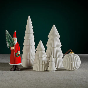 The ZODAX CERAMIC HOLIDAY TREE WHITE is a 12.70 cm x 26.04 cm white ceramic sculpture with four fluted tiers and a smooth, pointed tip, displayed elegantly on a plain background.