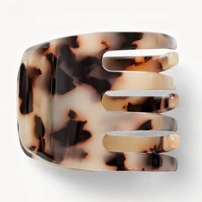The MACHETE - MINI CLAW by MACHETE is an Italian acetate hair clip in a brown and beige tortoiseshell pattern, featuring a rounded top and multiple curved gripping prongs, shown against a plain white background.