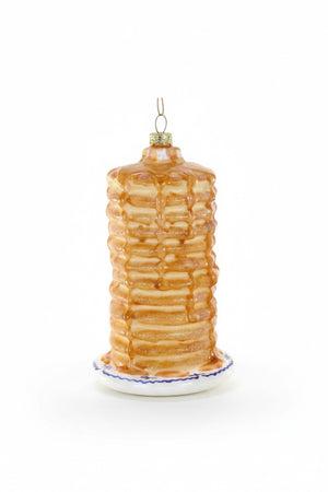 The BIG STACK ORNAMENT by CODY FOSTER is a delightful Christmas tree decoration shaped like a tall stack of pancakes with syrup on a white plate with a blue rim, gold cap, and hanging loop—perfect for collectors or as a unique holiday gift.