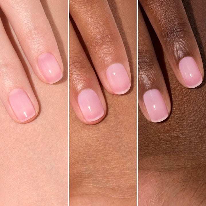 A pink serum drop labeled with its ingredients: raspberry extract (strengthens nails), AHAs (restore and harden), and sweet almond oil (nourishes). The text highlights that MANUCURIST - ACTIVE GLOW CARE POLISH by MANUCURIST INC is 85.5% plant-based—making it the ideal nail strengthener for achieving healthy, glass-like nails.