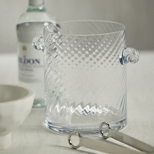 The BAGATELLE SWIRL GLASS ICE BUCKET by ZODAX features a clear, textured spiral design with diagonal swirls and two round handles—a modern bar accessory shown on a white background.