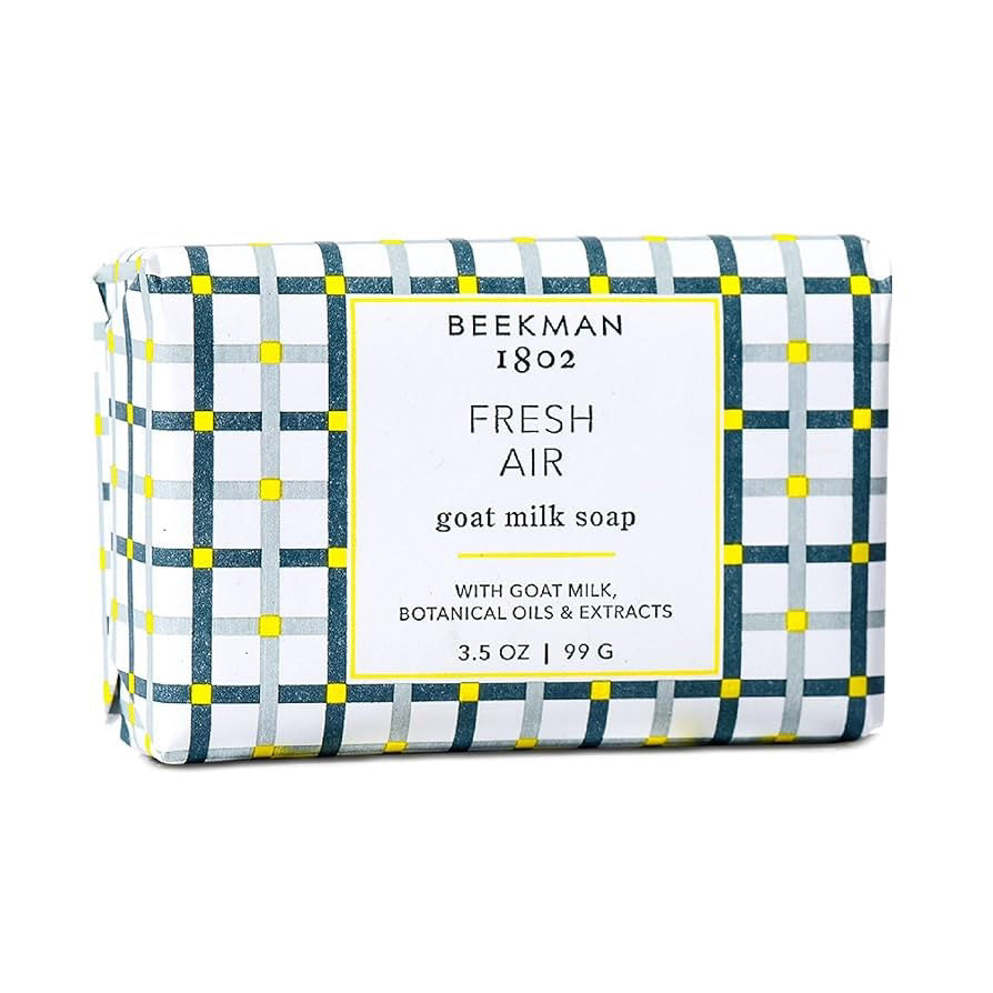 The BEEKMAN - FRESH AIR BAR SOAP 3.5OZ by BEEKMAN - STA ELEMENTS comes wrapped in white paper with a blue, green, and yellow checkered pattern, and features moisturizing goat milk, botanical oils, and extracts. Net weight: 3.5 oz (99 g).
