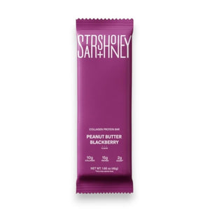 A purple STARS+HONEY - PEANUT BUTTER BLACKBERRY protein bar rests on a beige surface, with its wrapper highlighting 10g collagen, 15g protein, and 2g sugar.