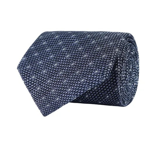 A rolled-up sky blue polka dot grenadine woven silk tie by Amanda Christensen, beautifully showcasing Italian craftsmanship, is displayed against a white background.