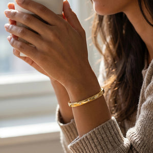 The ELLA STEIN Lucky 7 Cuff Bracelet by ELLA STEIN is a delicate, open gold-plated bracelet featuring evenly spaced small round diamonds, shown against a plain white background.