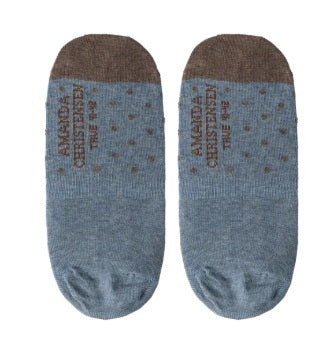 A pair of AMANDA CHRISTENSEN TRUE DOT Invisible Socks in Sky Blue Melange, crafted from a soft combed cotton blend and adorned with playful polka dots. “AMANDA CHRISTENSEN TRUE W.B.” is printed on the soles—an elegant option for those who value luxurious men’s accessories.