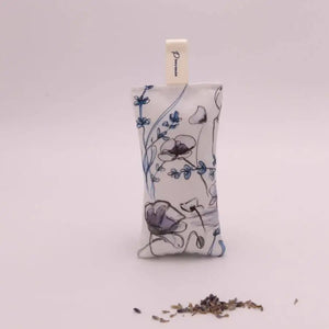 A L'AUGUSTE PROVENCE French Lavender Sachet from Provence is displayed in front of a bundle of dried lavender on a white surface.