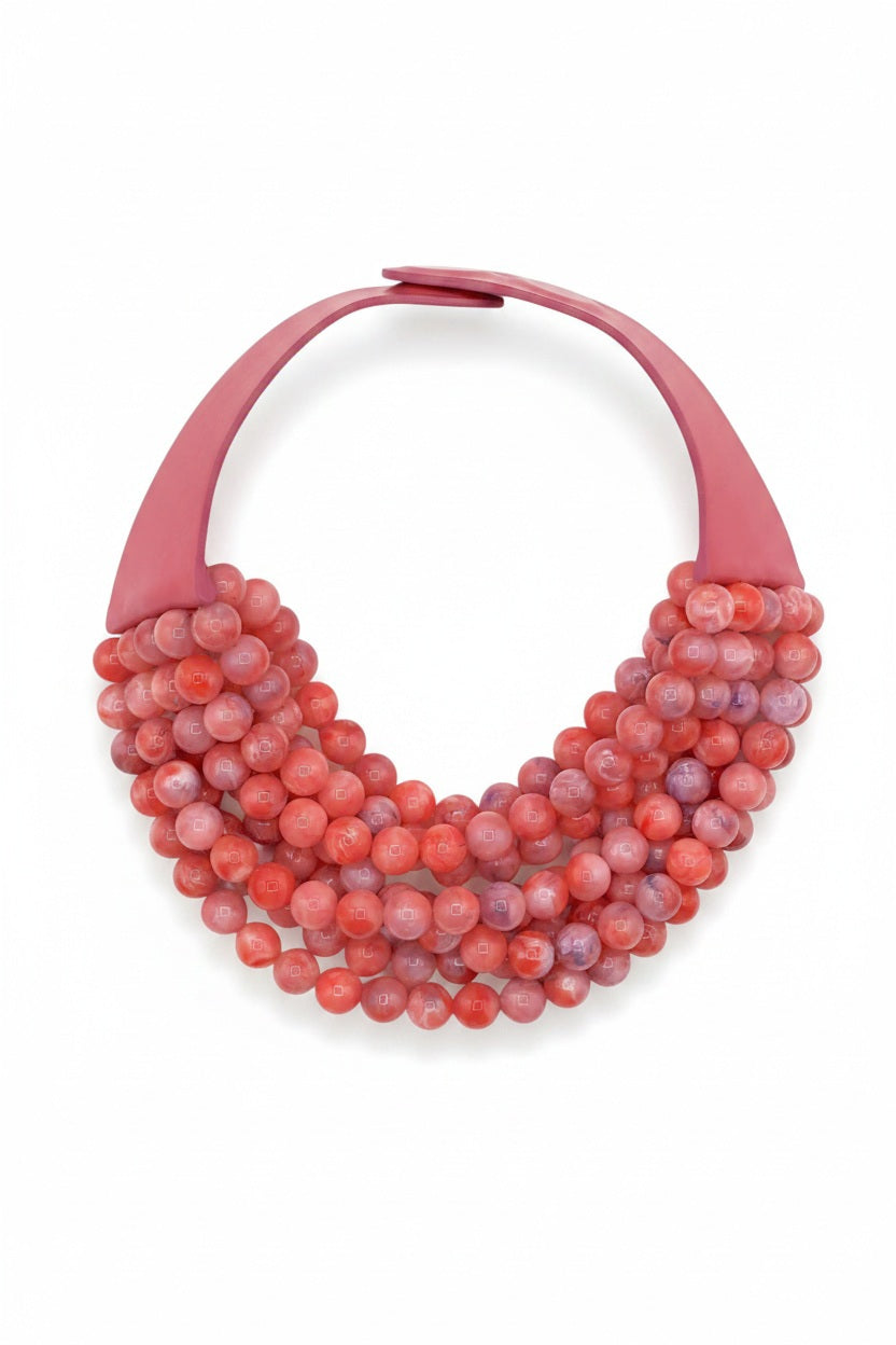 The FAIRCHILD BALDWIN - THE BELLA NECKLACE showcases layered strands of iridescent green Italian resin beads with a faceted design for a shimmering effect, finished with a smooth light green clasp that complements its vibrant hues.