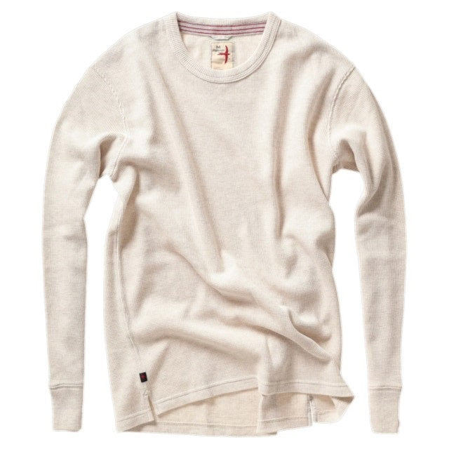 Close-up of the RELWEN Bi-Waffle Crew in Oatmeal, a textured off-white thermal shirt made from 100% cotton and featuring a visible collar along with a fabric tag labeled “RELWEN M” stitched with red thread.