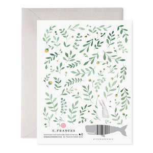 The E. FRANCES PAPER Easter Egg Hunt Greeting Card features "Happy Easter" in a handcrafted watercolor design with green leaves, pastel eggs, and a bunny illustration on a gray envelope. Made in the USA with care by E. FRANCES PAPER.