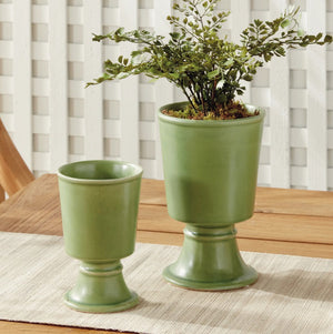 Two green NAPA HOME AND GARDEN Kelcy Footed Cachepots, each with a wide base and reactive glaze—one taller than the other—are displayed against a plain white background.