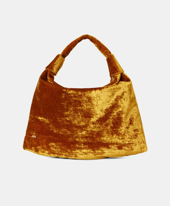 The MOMONI - FRANCOIS VELVET BAG by MOMONI is a teal hobo bag with a slouchy design and a single handle. Made in Italy, it features a small, gold &quot;m&quot; logo on the lower left side. The bag has an overall soft and plush texture, crafted from luxurious crushed viscose velvet.